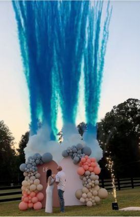 Decorative setup with balloons and blue smoke effect outdoors